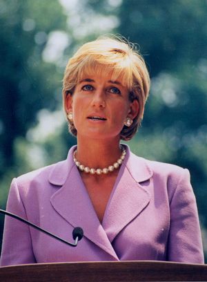 A news-style photograph of Diana, Princess of Wales wearing a formal-style pink jacket, pearl earrings and a pearl necklace